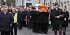 Mickey Brady's family carry him down Canal Street.