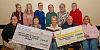 Members of the Three Ways Over 30's present cheques to the Kevin Bell Repatriation Trust and Three Ways Community Association.