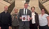 Justin McNulty presents the petition to the Stormont Assembly along with members of the Sherry and Garvey family.