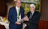Former SDLP council chairperson Michael Savage presents a retirement crystal to Dermot Curran in 2023.