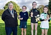 Newry, Mourne and Down District Council Chairperson, Councillor Glyn Hanna with the top three finishers in the Individual Girls race. Included are winner Emily Mc Greevy, Glasswater Primary School (centre), runner-up Sophia Murtagh, Ballyholland Primary School (left) and third placed Meabh Murtagh from Carrick Primary School, Burren.