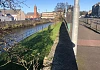 The grassy area to the right of the river denoted where the Mill Race once openly flowed. Photograph taken by the author.