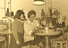 A pupil from Kilkeel Primary School watching one of the employees at the Kilkeel Knitting Factory at work during a school visit to the factory in 1979. Newry and Mourne Museum Collection