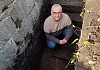 John McCabe investigating the hidden stream and stone structure.