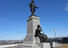  A statue of Thomas D'Arcy McGee that stands at the Ottawa Parliament Building in Canada with the young nation listening  to his wisdom.
