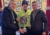 Mickey Brady along with Brendan Caraher son of the late Fergal present the winners trophy to Eoin Martin