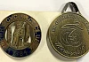 An 1884 members badge for Newry Cycling Club and a 1991 maracycle medal. Newry & Mourne Museum Collection