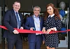 Newry, Mourne and Down Council Chairperson Mark Murnin cuts the ribbon to officially open Granite Exchange in Newry with Owner Jonathan McKeown and Manager Colleen O&rsquo;Hare.