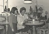 A pupil from Kilkeel Primary School watching one of the employees at the Kilkeel Knitting Mills at work during a school visit to the factory in 1979. Newry and Mourne Museum Collection