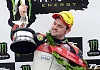 Michael Dunlop celebrates on the podium after winning the Monster Energy Supersport race two at the 2014 Isle of Man TT. Photograph: Pacemaker