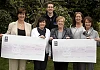 Members of the Moonwalk organising committee presenting cheques to Macmillan Cancer and TAG (The Active Group).