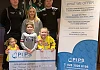 Members of the Quinn family present a cheque to PIPS Hope and Support.