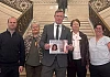 Justin McNulty presents the petition to the Stormont Assembly along with members of the Sherry and Garvey family.