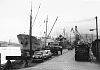 The Port of Newry in the 1960s. Timber is pictured here being unloaded from a Scandinavian ship. The port was still busy at this time but the limitations of the Newry Ship Canal meant that larger ships could not come to Newry and the docks closed in 1974. Courtesy of John Matthews