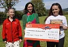 Katie Killen presents a cheque for £40,207.21 to Bébhionn Hardy and Kerry Anderson from Air Ambulance NI.