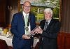 Former SDLP council chairperson Michael Savage presents a retirement crystal to Dermot Curran in 2023.