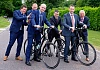 NIGTA members Ronan McCanny, left and Vincent Shannon get on their bikes for the NIGTA cycle run with a bit of help from NIGTA members Robert Adams, Ben Frazer, Niall O'Donnell and Robin Irvine, NIGTA CEO. Photograph: Columba O'Hare/ Newry.ie