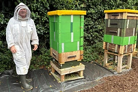 Peter Haughey, Bee Specialist at Greater Armagh Road Men’s Shed, pictured next to the hives. Specialist equipment such as beekeeping overalls and a honey extractor was purchased through a Housing Executive community involvement grant.