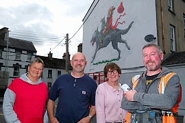 Theresa Hince, Garry McElherron, Iúr Cinn Fleadh; Nina West and artist Kev Largey/ KVLR with the  new fleadh mural at Kilmorey Street in Newry, a tribute to the late artist John Farrelly. Photograph: Columba O'Hare/ Newry.ie 