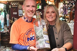 Anthony Morgan with Sabrina McTaggart with some of the money raised for Rathore School. Photograph: Columba O'Hare/ Newry.ie 