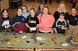 ey stage 4 girls from St Paul’s Bessbrook learn how to wire a plug with tutor Joanne Rea (centre back); Claire King from Women's Tec (second right); and Caitlin Magee from the Housing Executive (right) as part of a special construction day event at Women’s Tec, who are partnering with the Housing Executive to encourage local young people to consider careers in a range of trades.