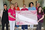 Representatives from Breast Mates Newry receive a cheque from St Mary's High School staff and pupil.
