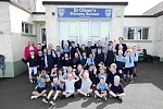 Liz Kimmins joins pupils at St Oliver’s Primary School, Carrickrovaddy, Cullyhanna along with school Principal Mrs Donagahy, as new temporary 20mph speed limit signs are switched on outside the school to improve road safety for pupils, parents and staff. 