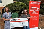 Brea Friel, left, presents a cheque to Hazel Stirling, Alzheimer’s Research UK - NI