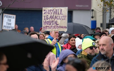 Justin McNulty MLA holds a banner aloft at the rally. Photograph: Columba O'Hare/ Newry.ie 