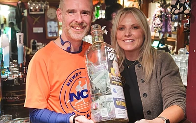 Anthony Morgan with Sabrina McTaggart with some of the money raised for Rathore School. Photograph: Columba O'Hare/ Newry.ie 