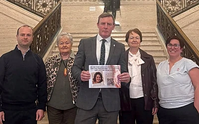 Justin McNulty presents the petition to the Stormont Assembly along with members of the Sherry and Garvey family.