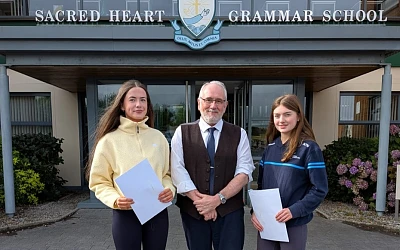 Sacred Heart Principal, Shane Comer, with Ellen Webster and Sinead O’Neill who got their GCSE results at Sacred Heart Grammar School.
